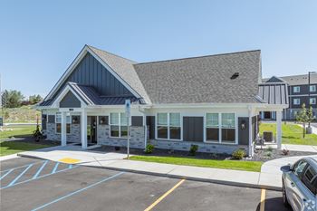 A building with a parking lot in front of it.